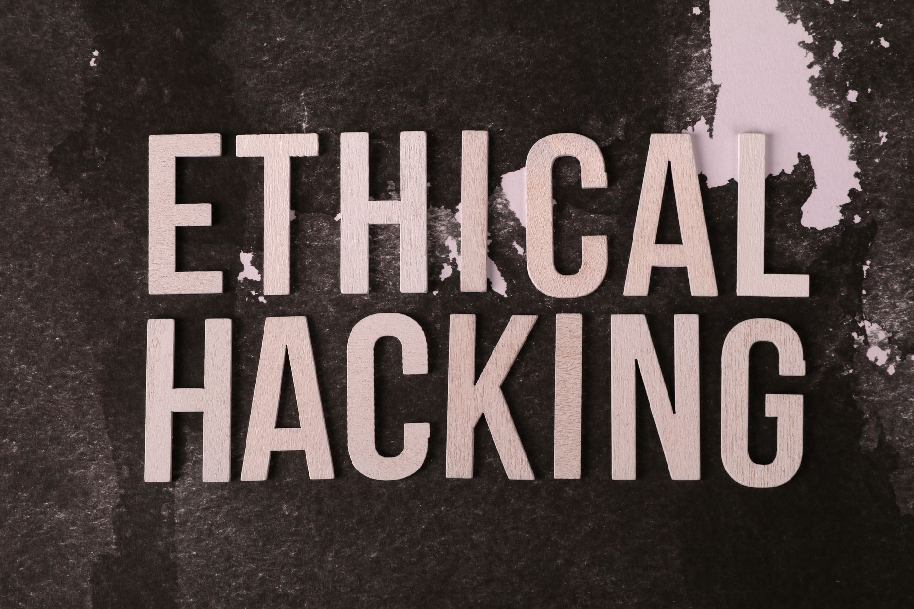 Creative composition with 'Ethical Hacking' text on textured background for cybersecurity theme.