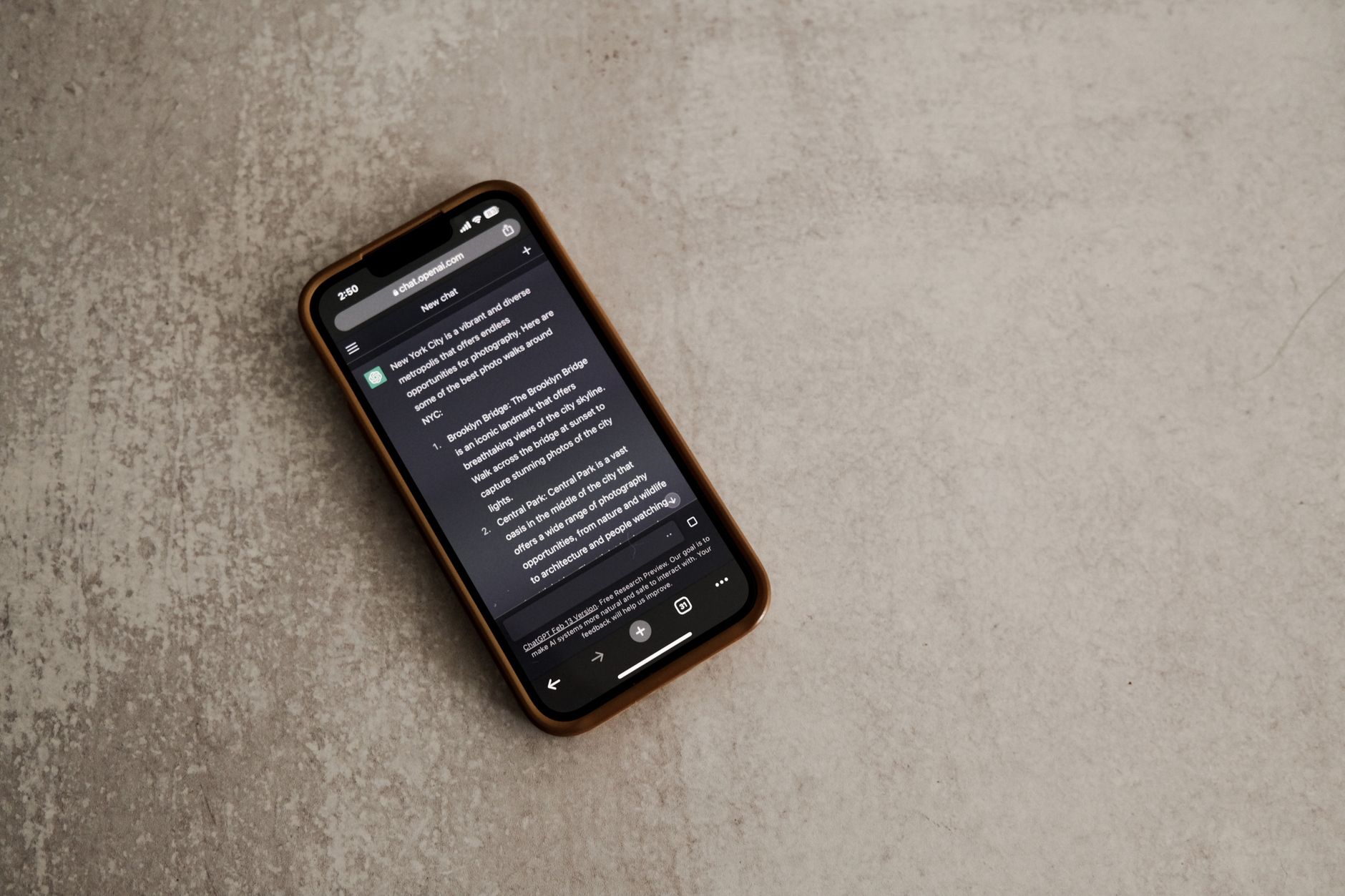 A smartphone displaying a messaging app screen, placed on a textured surface.
